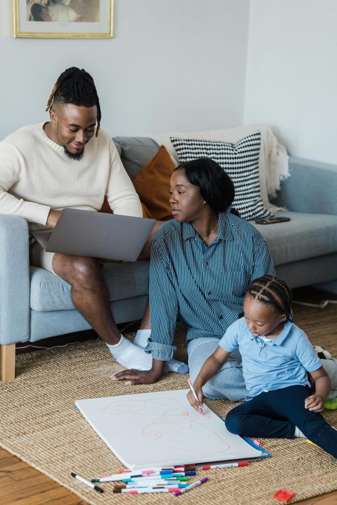 Zimbabwean parents discussing back-to-school preparations and school readiness with their child at home during the festive holidays