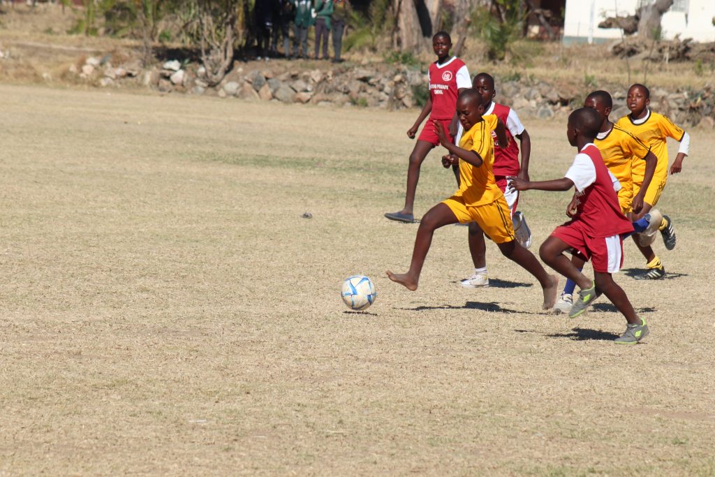 Primary school learners competing in ball games during Mangwe District school sports competitions, promoting teamwork, physical development, and participation beyond the classroom.