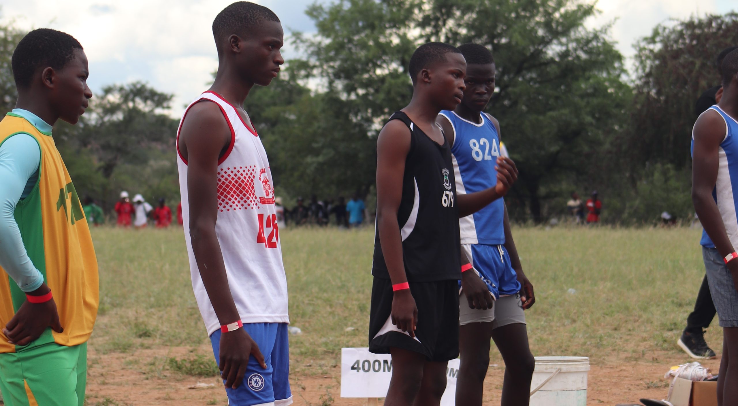 Athletes wearing identification wristbands while waiting for their race during the 2026 Matabeleland South Provincial Athletics at Manama High School.